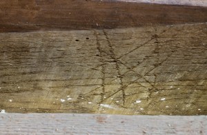 The carvings included criss-crossed lines, interlocking V-shapes to invoke the protection of the Virgin Mary, and scorch marks made by directly burning the timber with a candle. They were intended to trap demons and witches at work.