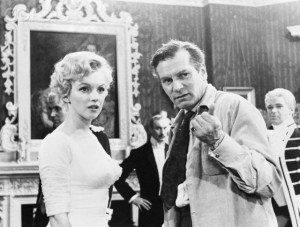 1957, London, England, UK --- Original caption: London, England: Sir Laurence Olivier, co-star and director of the film, emphasizes a point for actress Marilyn Monroe on the set of their movie 