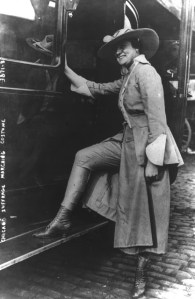 A woman models her marching costume for a suffrage parade held on June 7, 1916