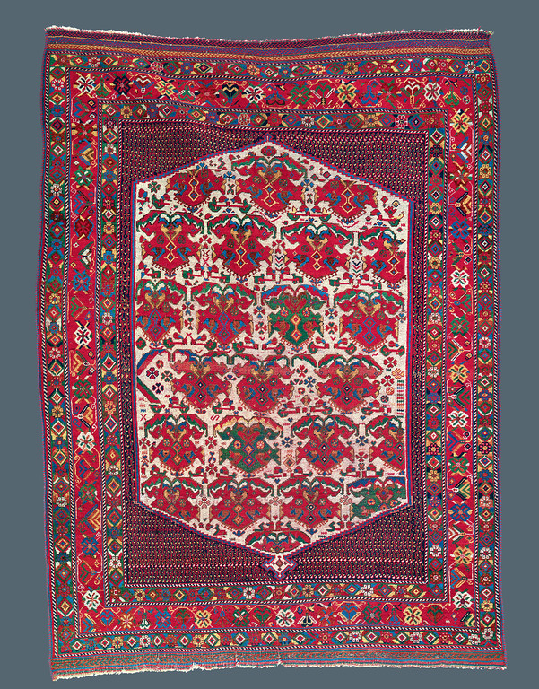 Afshar, Southwest Persia, Late 19th C., 4'0" X 5’6" Afshar, Southwest Persia, Late 19th C., 4'0" X 5’6" Afshar, Persia. Mid 19th c. 3' 5" x 4' 4" Afshar, Persia. Mid 19th c. 3' 5" x 4' 4" Published: “Oriental Rugs from Pacific Collections”, Murray L. Eiland, 1990. Page 79, plate #46. During the 19th century, the central medallion format, complete with complimentary corner pieces, was generally a design of large, formal workshop carpets. The nomadic weaver of this Afshar rug was inspired by the classic layout, but transformed it with her native, vibrantly colorful aesthetic. She dispensed with the classical formality, and instead focused on the purity of naturally derived color and added charmingly drawn animals to roam the indigo field. This rug exemplifies the true spirit of Afshar weaving.